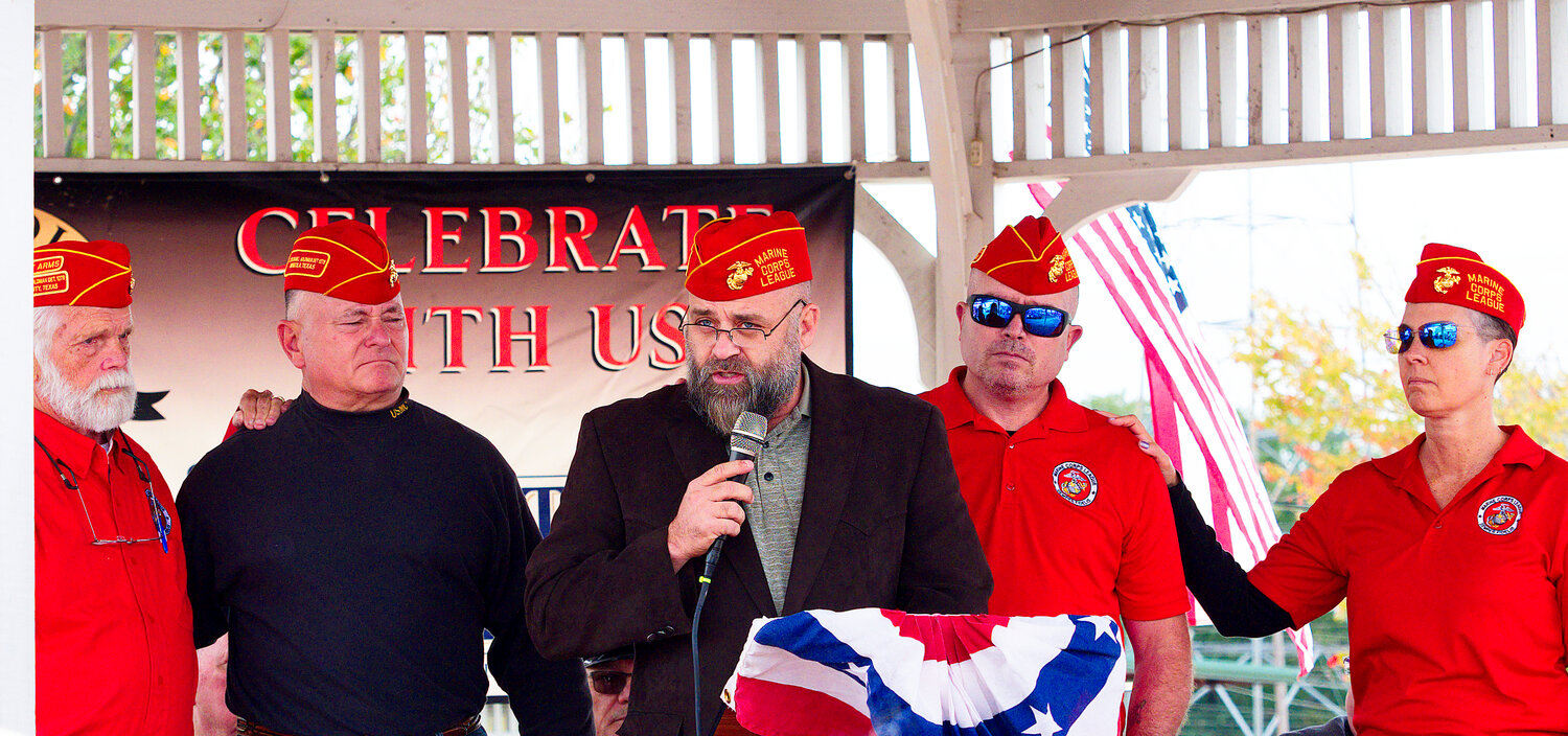 Kelly Smith, Precinct Two Constable and Marine Corps League detachment commander, addresses the Mineola Veterans Day gathering Saturday at the gazebo, surrounded by fellow Marine Corps League members.